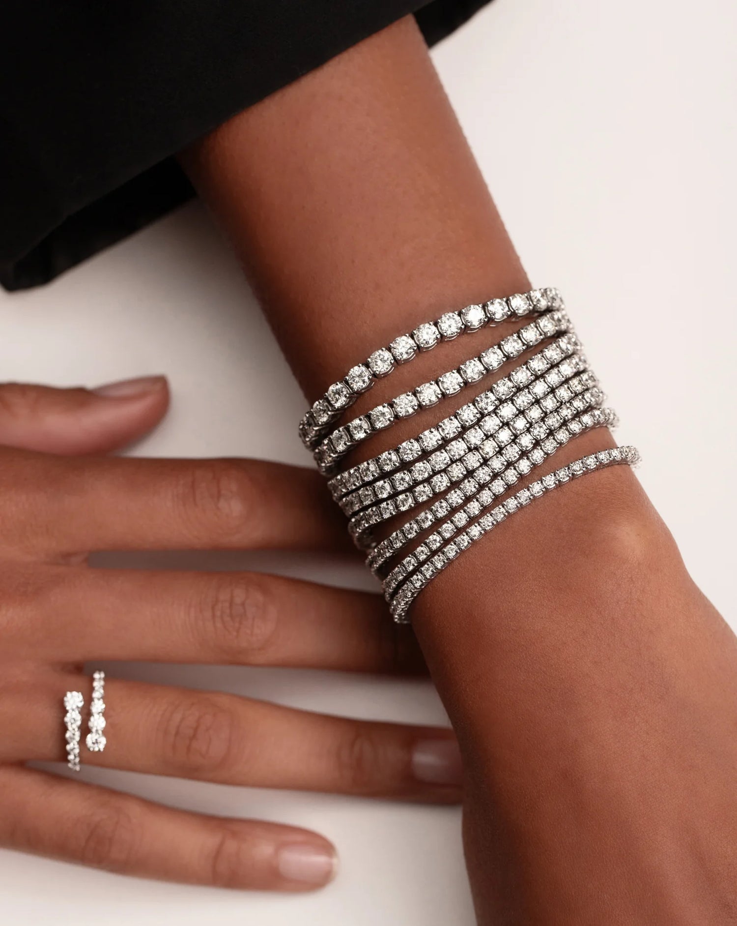 Hand wearing a tennis bracelet with lab-grown diamonds